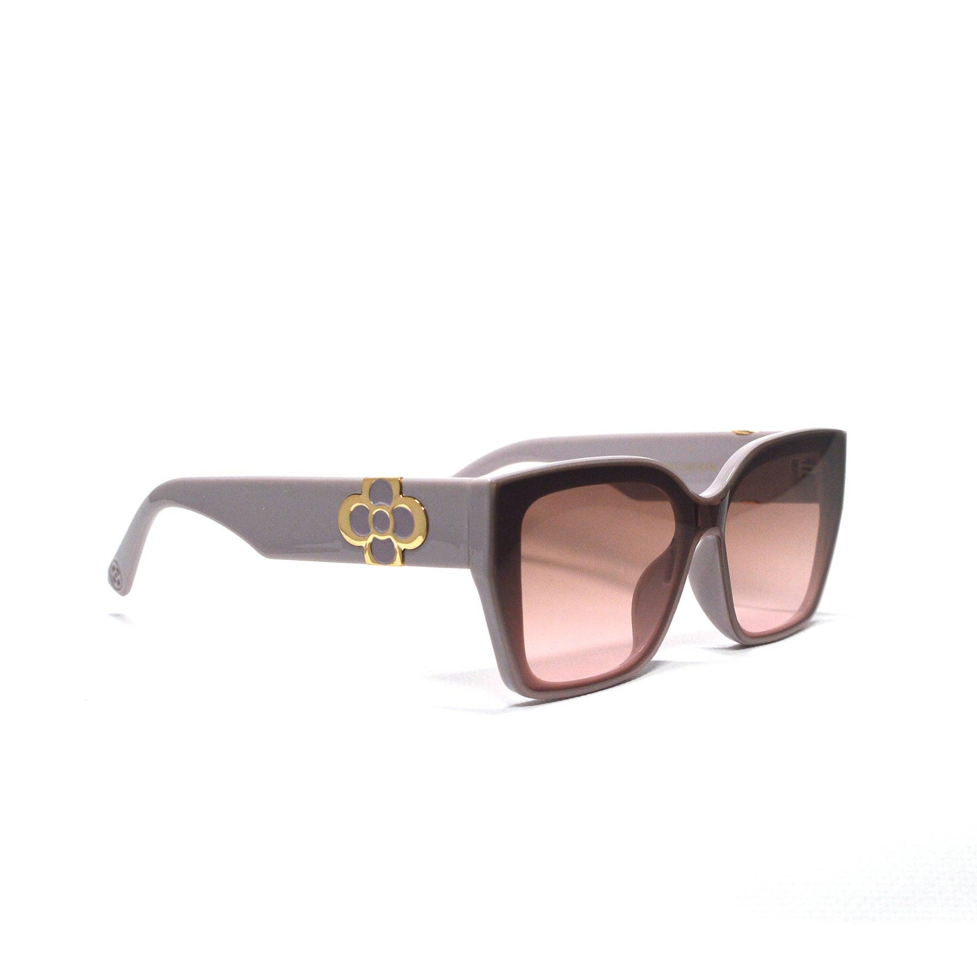 Sunglasses with a gold emblem on a white background
